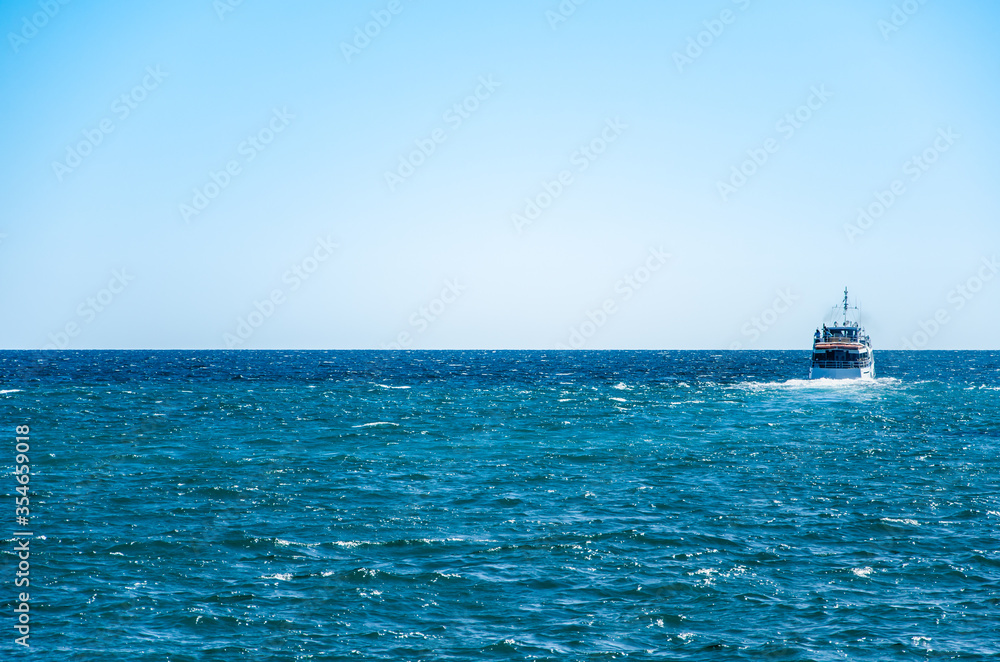Seascape ship sailing on blue sea background
