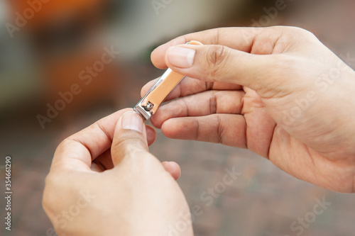 closeup of a man cutting nails