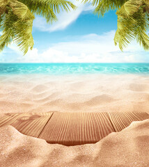 Tropical fine sandy beach with blured sea sun sky clouds background with wooden table top and empty space for product advertisement Montage of summer relaxation background