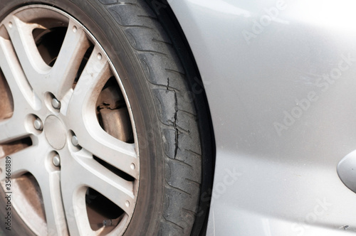 Tear marks on bald tires, car use unsafe tyre dangerous for vehicle. © ZhouEka