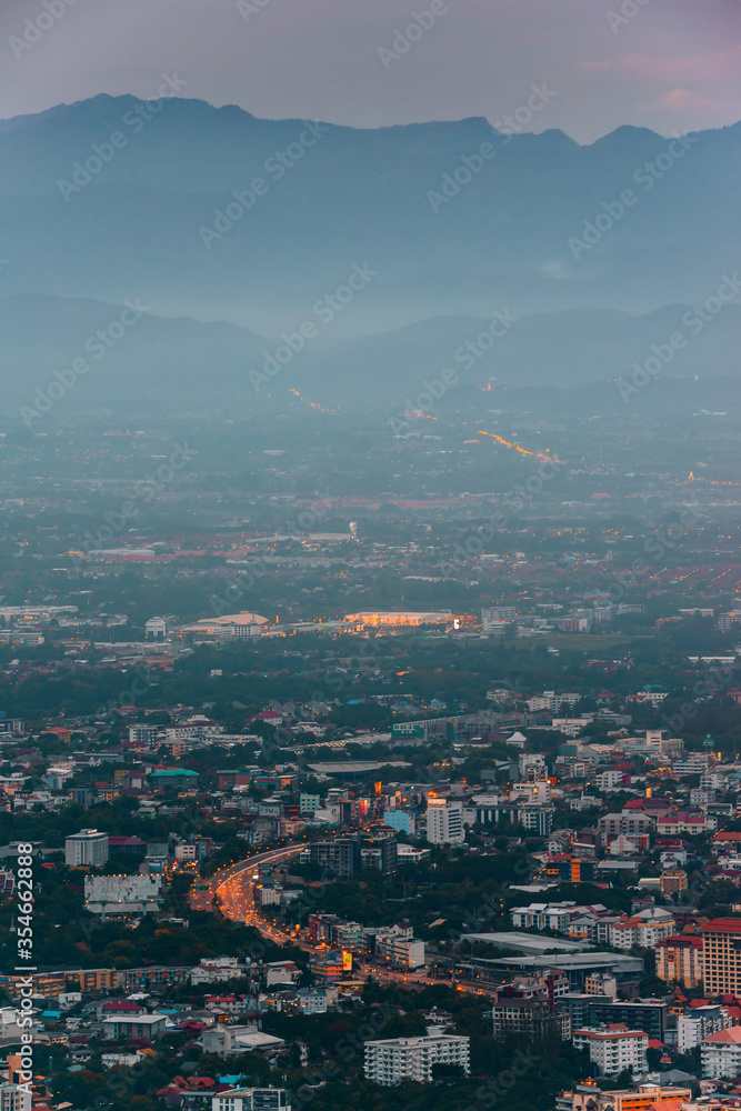 CHIANG MAI, THAILAND - May 27,2020:  Aerial view Chiang Mai City skyline and lights city in twilight night background from the aerial view point on top of mountain