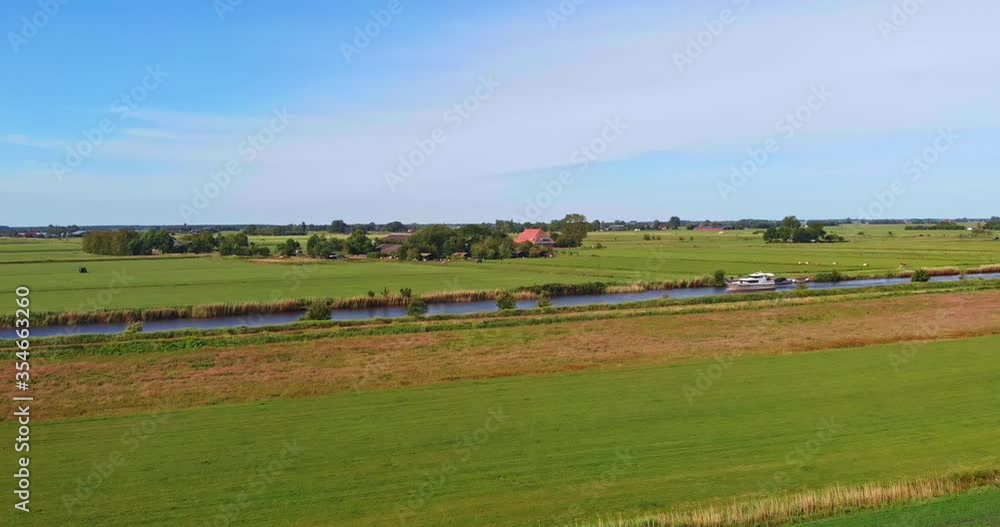 AERIAL: Yacht charter sailing trough dutch canal with beatiful weather during holiday times shot with drone in Friesland 4K/UHD AERIAL: Yacht charter sailing trough dutch canal with beatiful weather during holiday times shot with drone in Friesland 4K/UHD