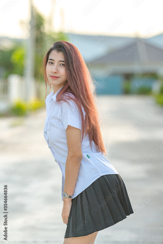 Portrait of asian or thai student university uniform beautiful girl relax and smile