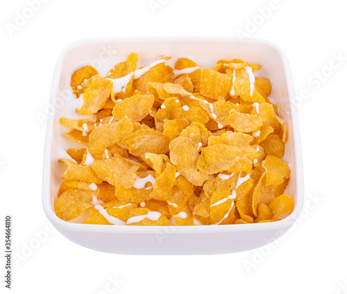 Corn flakes with milk in bowl isolated on white