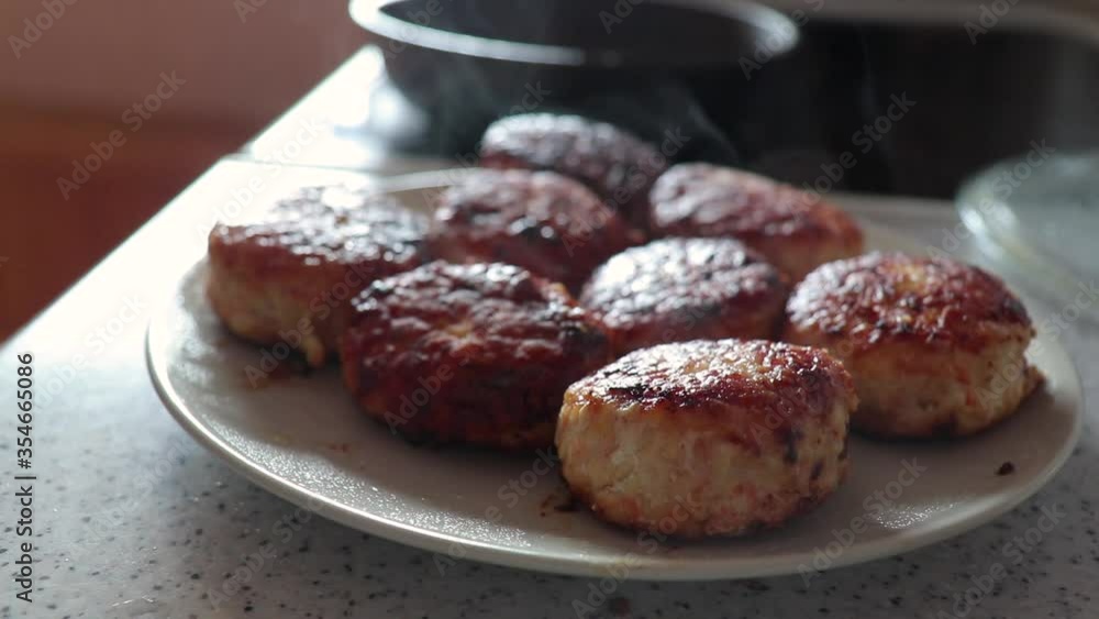 hand lifts the lid of the pan, hot steam comes from meatballs hand lifts the lid of the pan, hot steam comes from meatballs