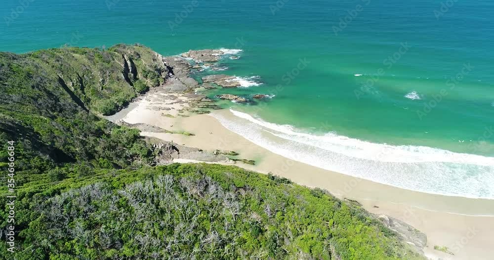 An aerial view shows waves lapping at Whites Beach in Byron Bay, Australia. An aerial view shows waves lapping at Whites Beach in Byron Bay, Australia.