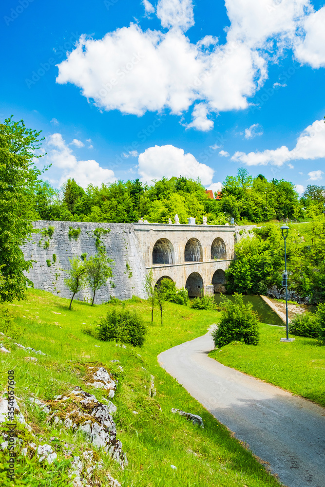 Croatia, beautiful 19 century stone bridge with arches in Tounj on Tounjcica river
