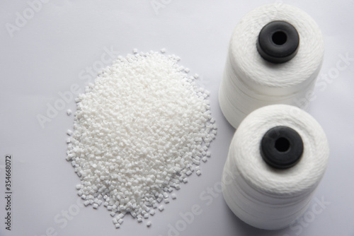 White Pet Chips Semi Dull,PET chips recycle,PET polyester chips &Raw White Polyester FDY Yarn spool with white background photo