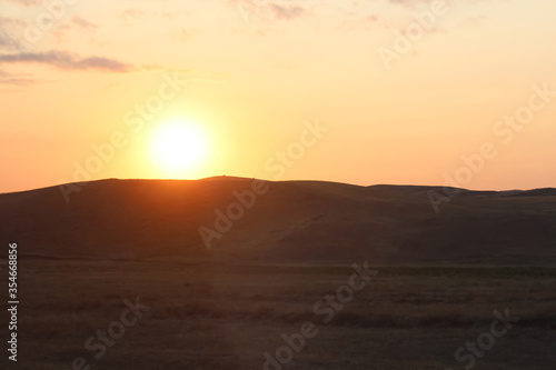 Hilly plain in the evening at sunset.