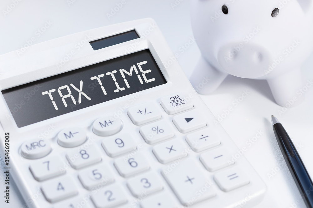 Word Tax Time on calculator. Business and tax concept on white background. Top view. Word Tax Time on calculator. Business and tax concept on white background. Top view.