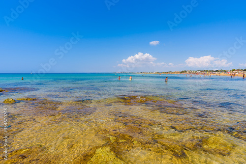 Beautiful crystal clear water. Isola delle Correnti (Currents Island), Portopalo di Capo Passero, Syracuse, Sicily. People bathing enjoying the beach. photo