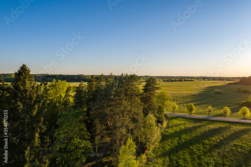 Aerial view of amazing sunset at summer season. Nature landscape. Fields  rivers and trees.