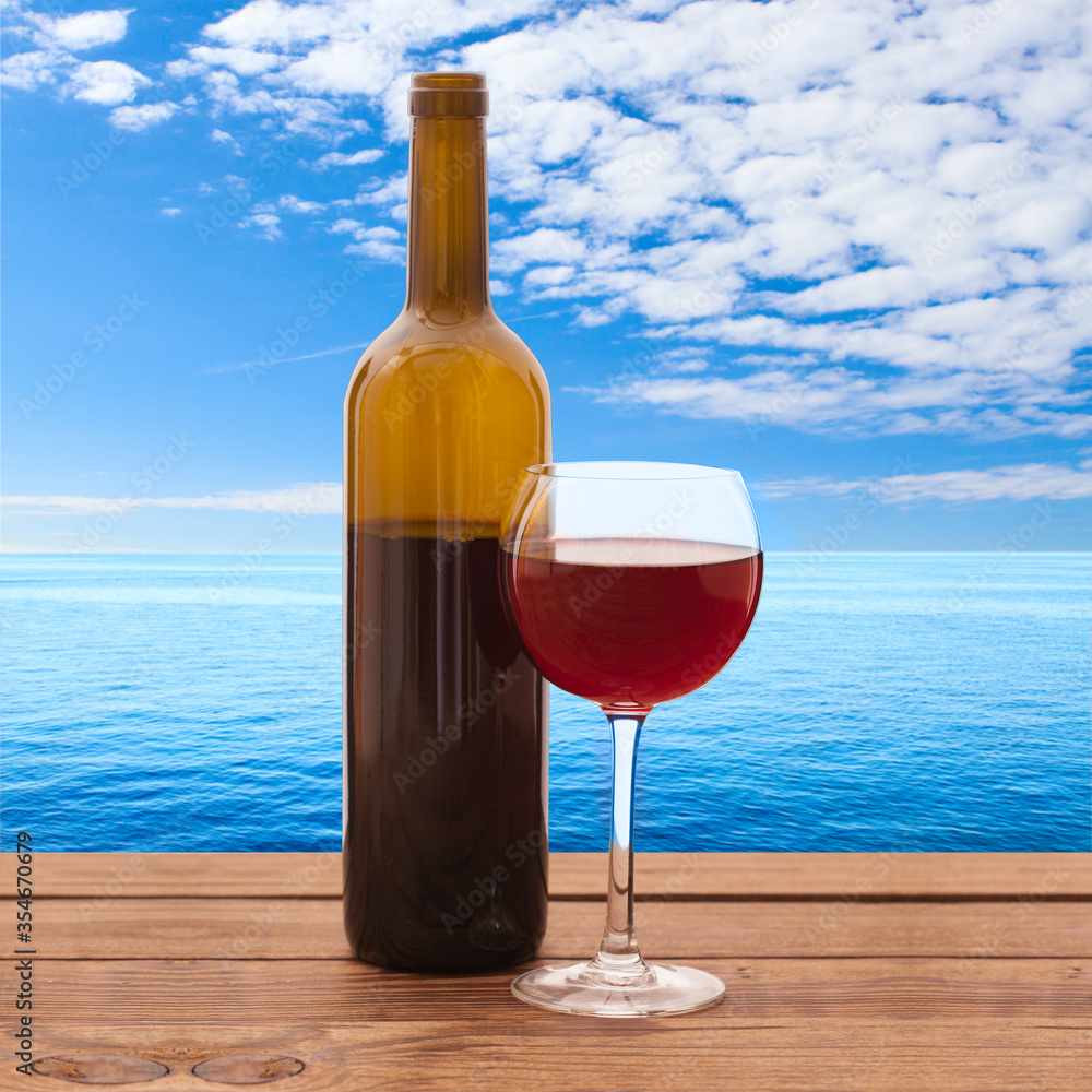 Glass and bottle of red wine unusually on wooden background. Glass and bottle of red wine unusually on wooden background.