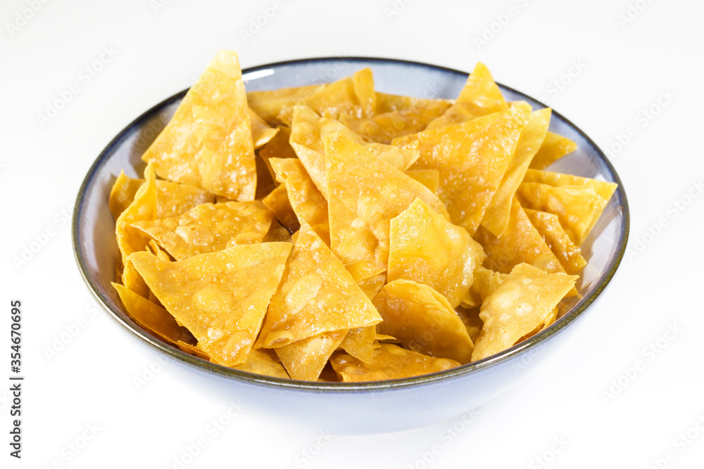 Beer snack in the blue bowl on the white background Beer snack in the blue bowl on the white background