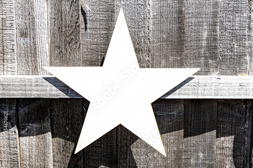 White metal Star on a wooden fence