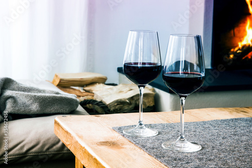 close-up of two glasses with red wine on table in living room