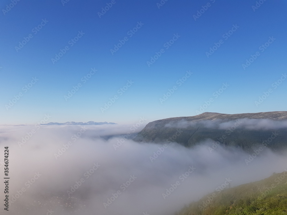 heavy summer fog over the tromsoe and tromsdalen settlement in northern Norway