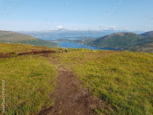 landscape with mountains and blue sky and ocean in northern norway on the whale island