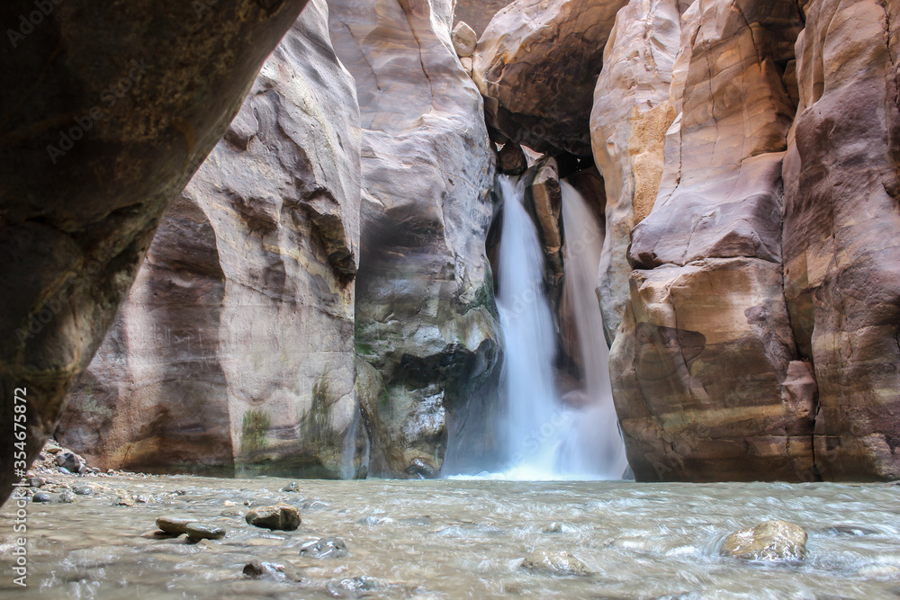A waterfall, feeding into the Wadi AlMujib river canyon near the dead sea in Jordan