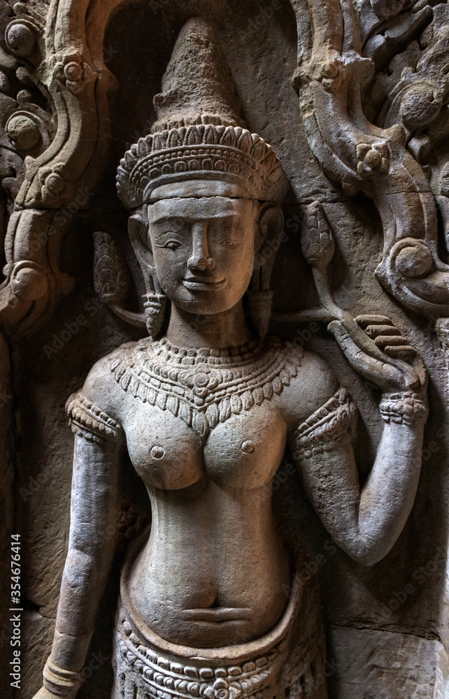 Old bas-relief of Apsara Deva is ancient stone carving on the wall in Angkor Wat temple.