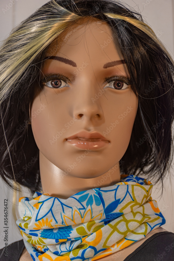 Female mannequin poses in the foreground for fashion photos with colored extension in the hair Female mannequin poses in the foreground for fashion photos with colored extension in the hair
