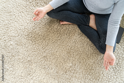 woman resting exercise by pose yoga meditation sit on carpet floor at home with copy space