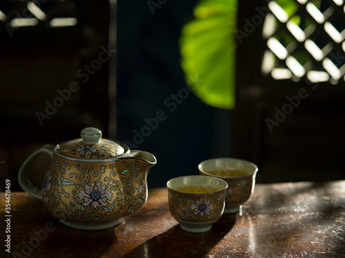 Close up view of nice china teapot and glasses on color back