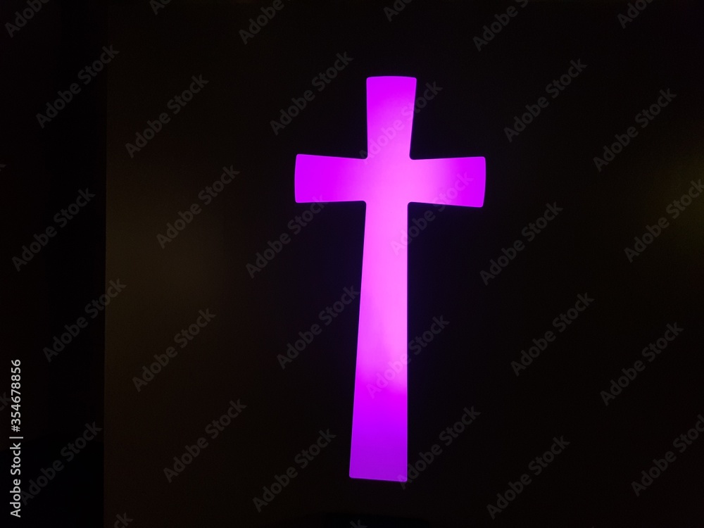 Obraz premium light pink and purple cross on dark background