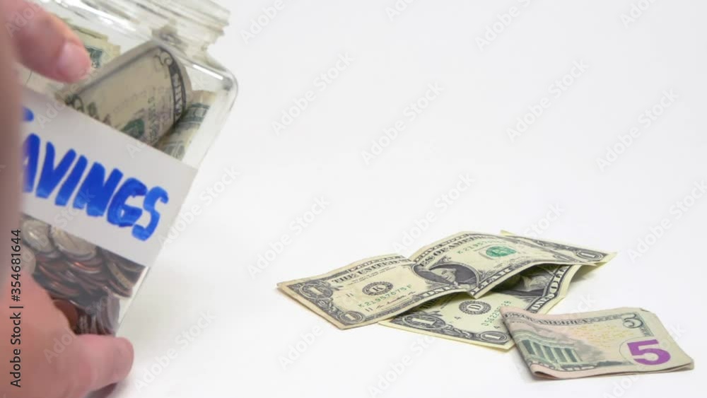 423 Close up of savings jar being emptied 423 Close up of savings jar being emptied
