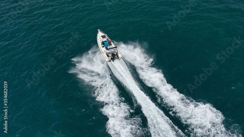Aerial drone photo of inflatable boat cruising in high speed near Mediterranean port