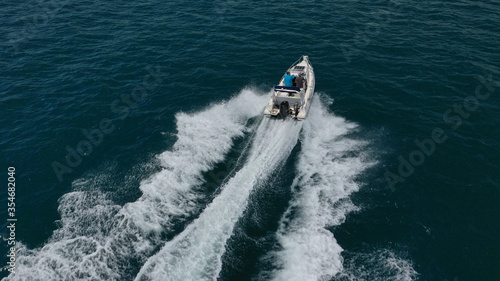 Aerial drone photo of inflatable boat cruising in high speed near Mediterranean port
