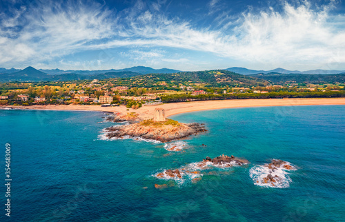 View from flying drone. Spectacular summer view of Torre di Bari tower. Aerial morning scene of Sardinia island, Italy, Europe. Wonderful seascape of Mediterranean sea.