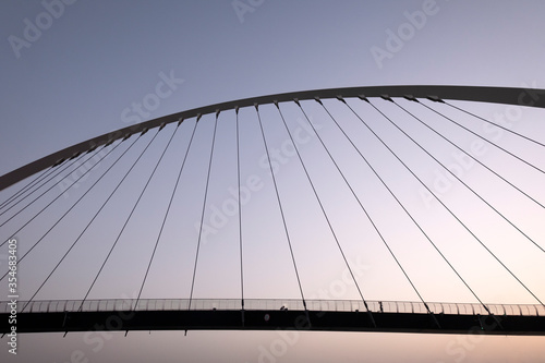 Photography Sillhouette  of tolerance bridge across the dubai canal  at sunset