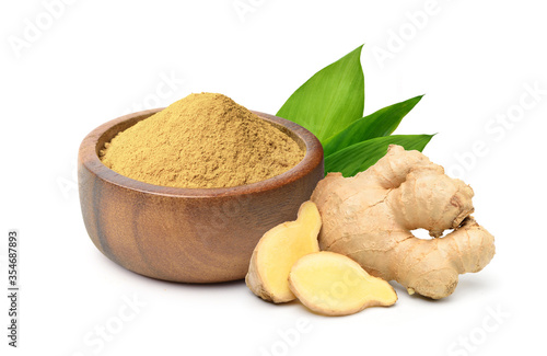 Valokuva Finely dry Ginger powder in wooden bowl with  rhizome (root) sliced and green leaves isolated on white background