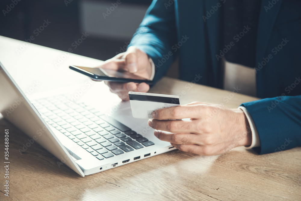 man hand credit card with phone and computer man hand credit card with phone and computer