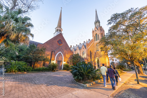 Tourists walking along the street in front of Methodist Church at night, New Orleans photo