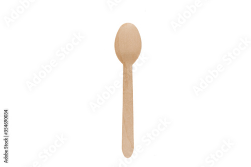 Eco natural wooden spoon with empty space. Disposable ecological utensils on white background. Sustainability of planet. Cardboard plate made of fiber of bamboo and bagasse.