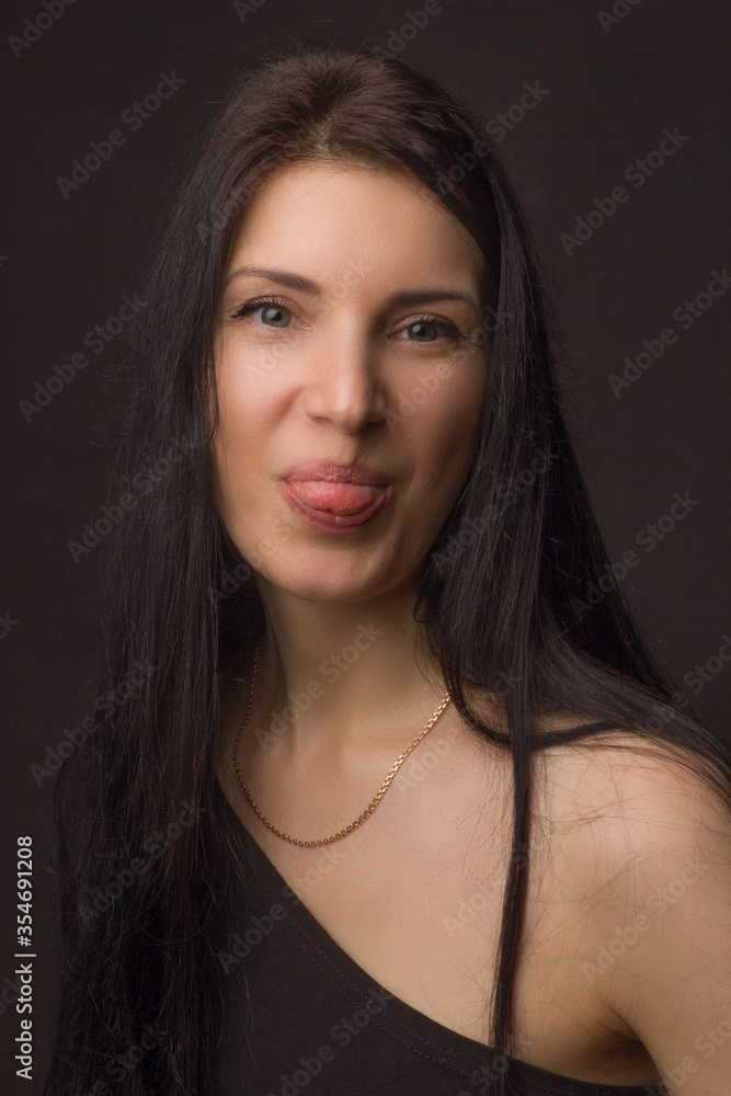 A brunette girl in a black dress with an open shoulder A brunette girl in a black dress with an open shoulder
