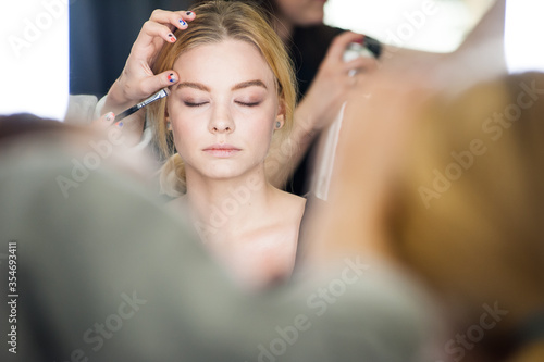Professional makeup for a woman in a beauty studio