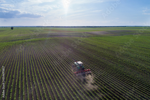 Tractor harrowing soybean field