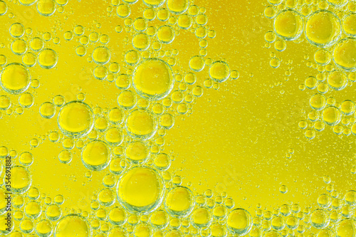 Golden yellow bubble oil or serum, Abstract Yellow water bubbles background