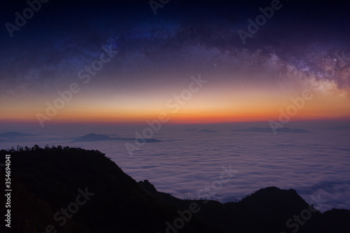 The silhouette of misty mountains and milky way