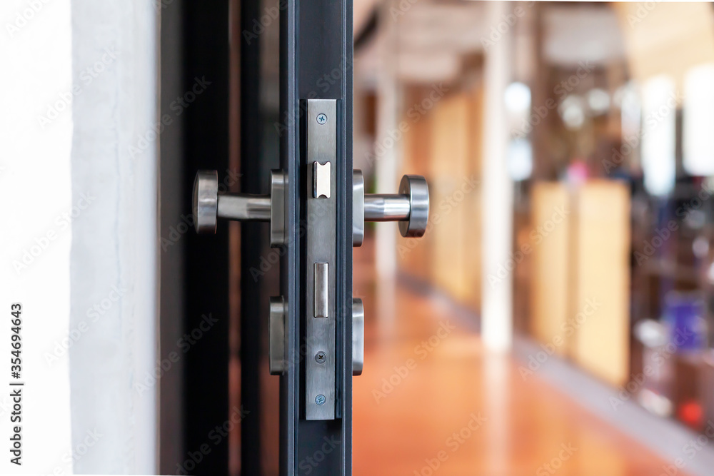Open unlocked doors in an empty secure vacant corporate business area, nobody, door knob lock side closeup. Door left open, office building security abstract concept. Simple entrance and a hallway Open unlocked doors in an empty secure vacant corporate business area, nobody, door knob lock side closeup. Door left open, office building security abstract concept. Simple entrance and a hallway