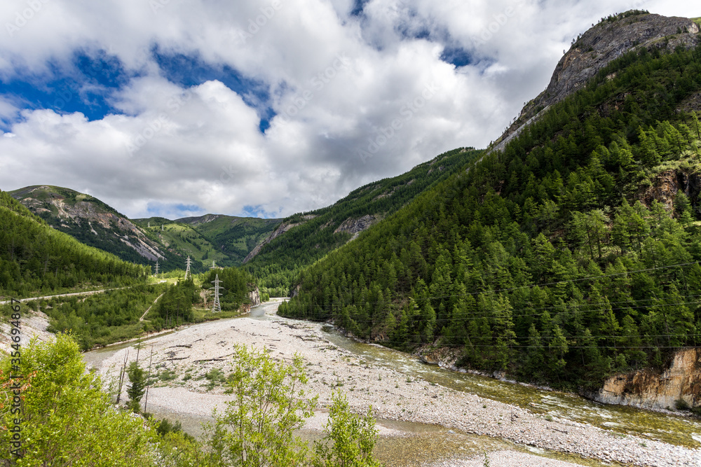 mouth of the Irkut River in the mountains in the summer forest