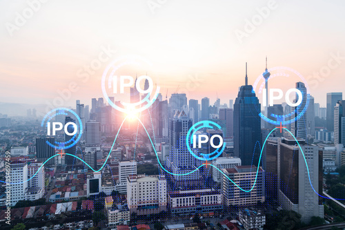 Hologram of IPO glowing icon, sunset panoramic city view of Kuala Lumpur. KL is the financial hub for transnational companies in Malaysia, Asia. The concept of boosting the growth by IPO process.