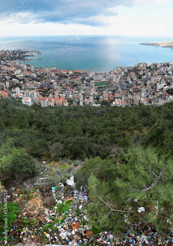 Large view of Jounieh, Lebanon,  from  the edge of the road in the mountain above the city with all the trashes left there by people who came to admire the panorama photo