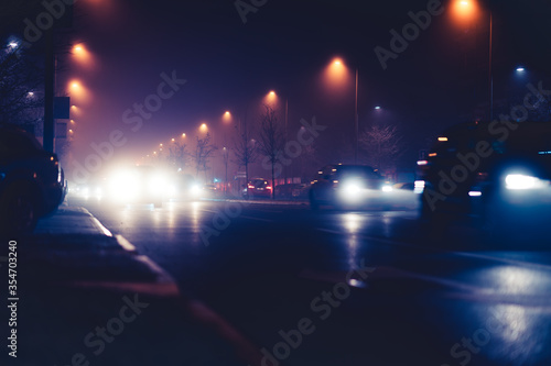 Traffic in the city with car lights and street lighting at night