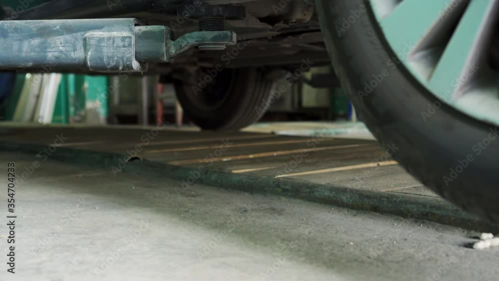 The operation of the hydraulic lifting gear for cars at the service station. The operation of the hydraulic lifting gear for cars at the service station.