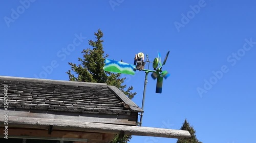 A wind pinwheel on top of a roof as a concept of alternative energy source like eolic energy or wind power, to protect the environment and change to a oil free world