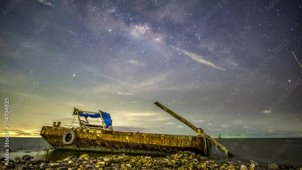 The Milky Way in a depressed atmosphere has a moon rising to the left. And there are clouds with rain and right lightning.